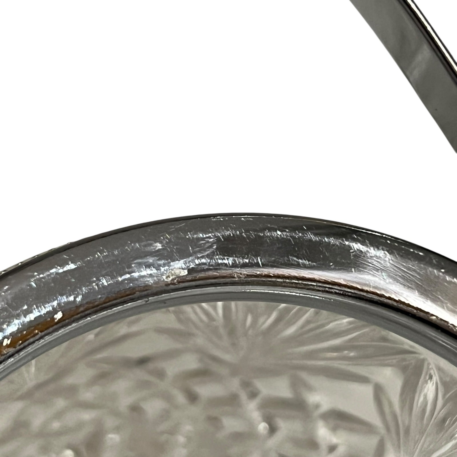Close up of a French vintage glass ice bucket with silver rim on a white background