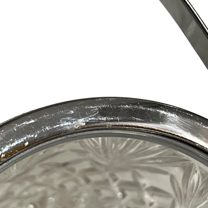 Close up of a French vintage glass ice bucket with silver rim on a white background