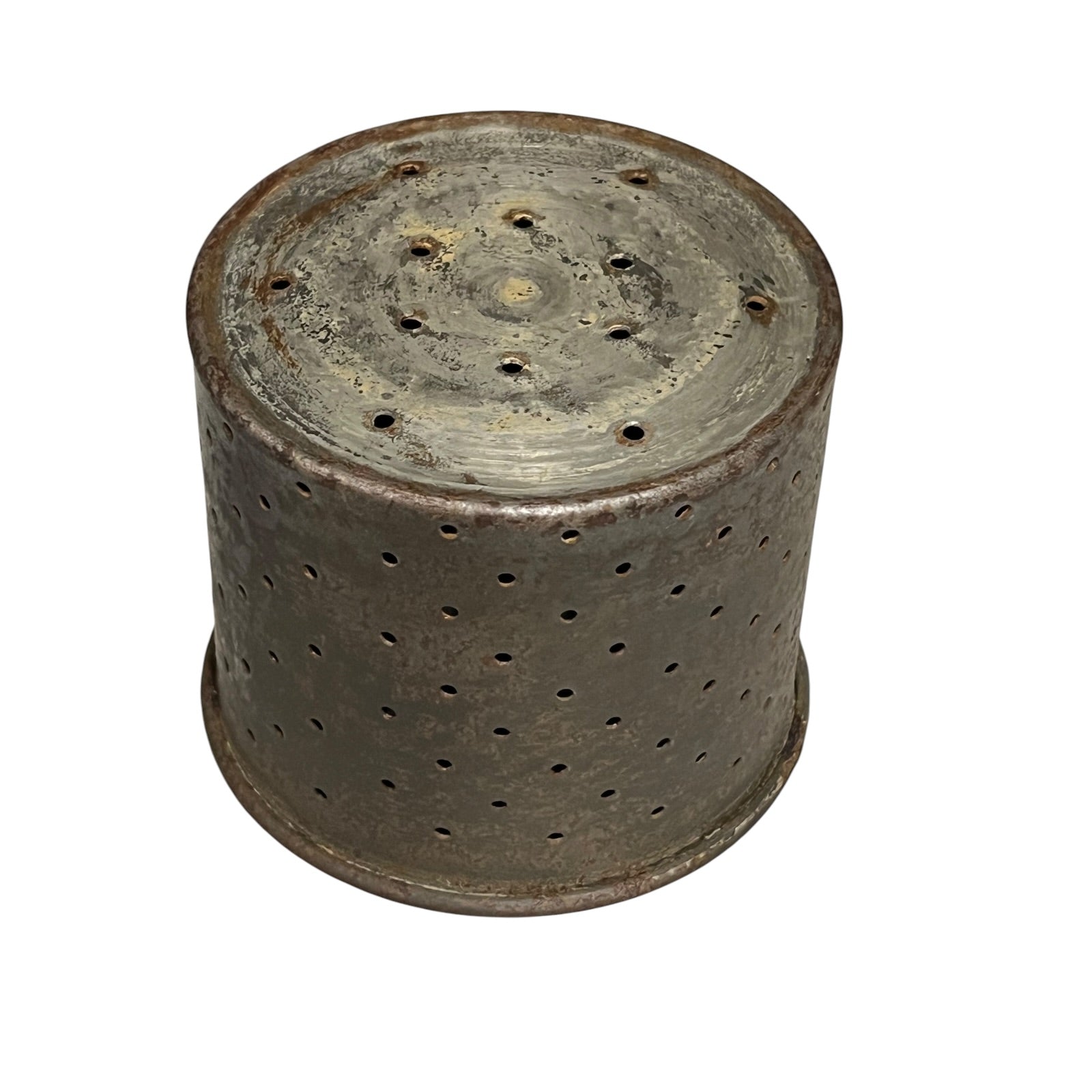 Close-up of a vintage fruit press with holed container on a white background