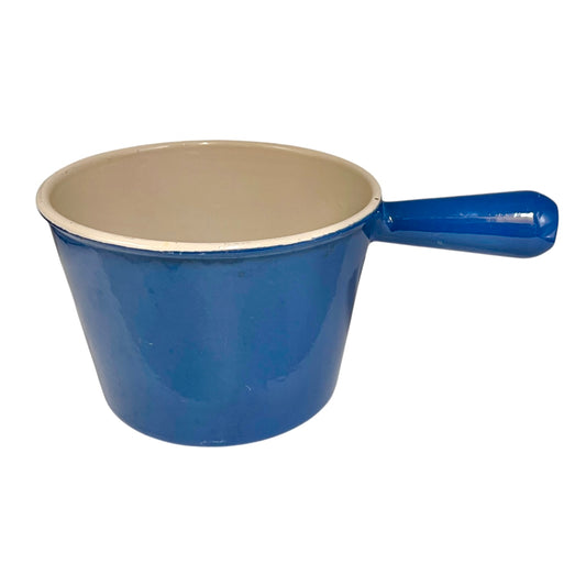 Blue Le Creuset cast iron pan with beige interior on a white background