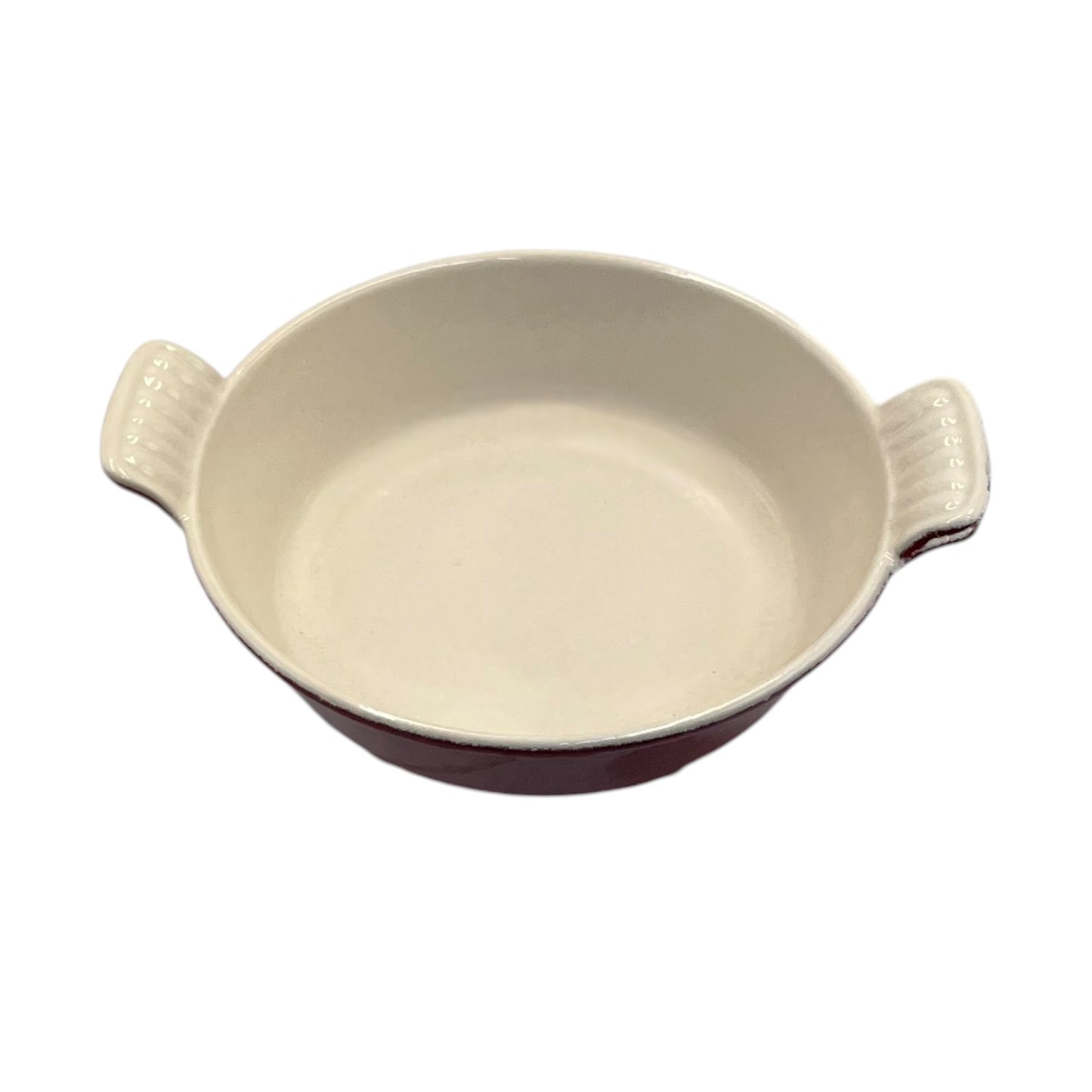 An oval ceramic baking dish with two side handles, featuring a glossy off-white interior and a dark reddish-brown exterior, shown against a plain white background.