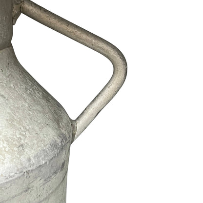 Close up of a vintage metal milk churn on a white background