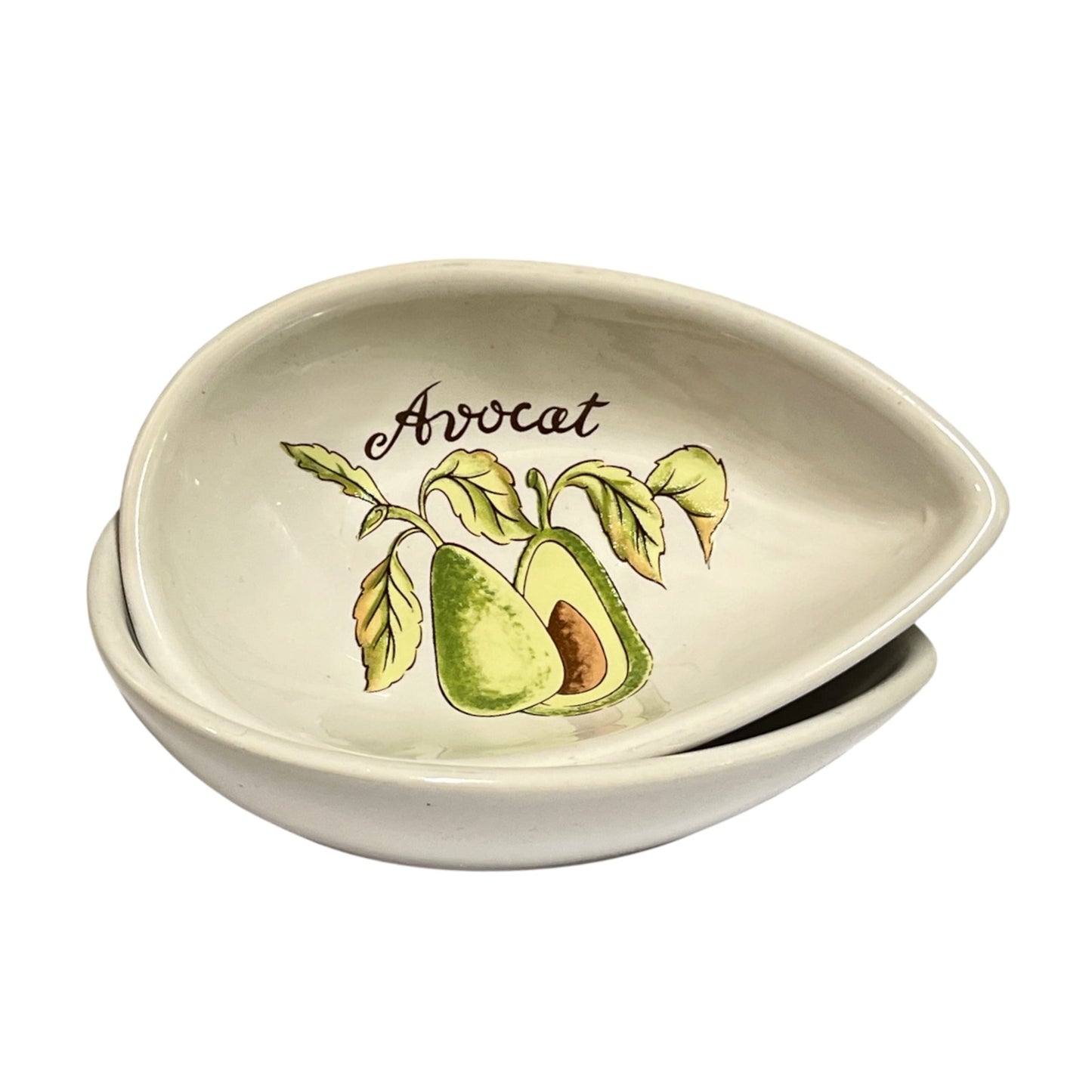 Two stacked ceramic bowls with a white glaze, featuring a painted avocado illustration and the word 'Avocat' on the front of the upper bowl, shown against a plain white background.