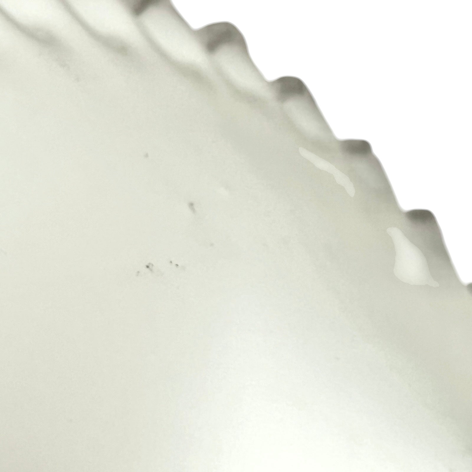 close up of white glass lampshade on a white background 