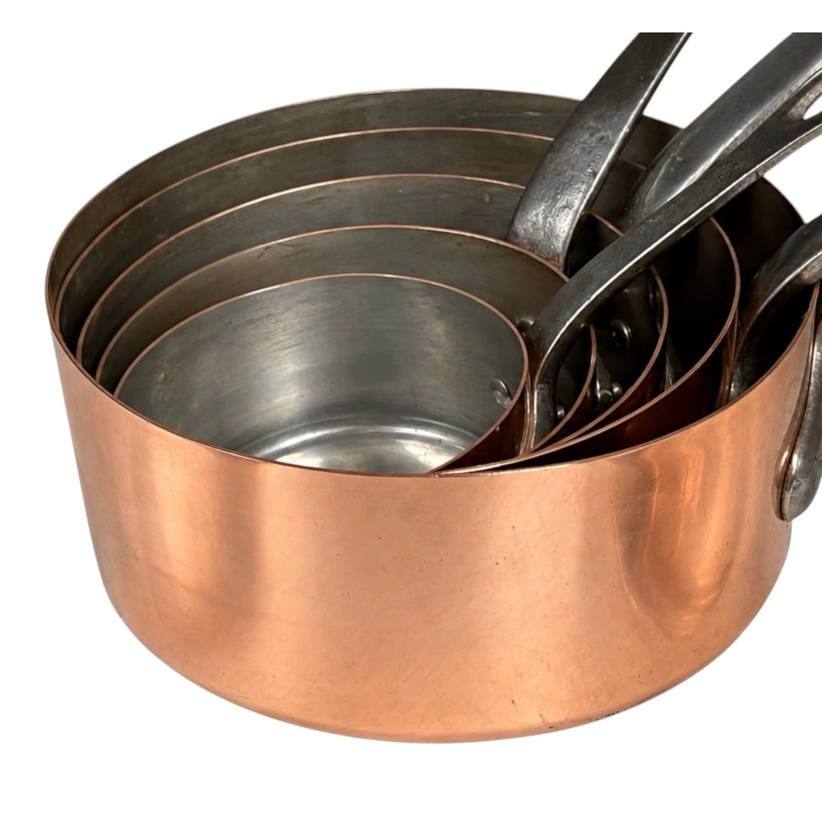 A set of nested copper and stainless steel measuring pots with handles, shown on a plain white background.