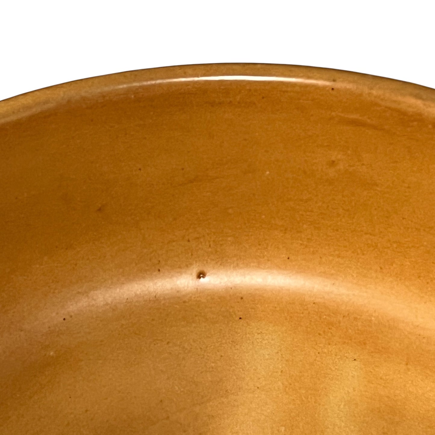 Close-up of a brown ceramic bowl with a smooth surface.