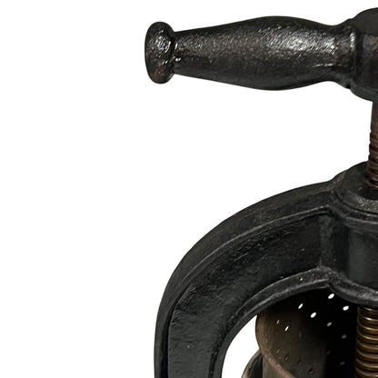 Close-up of a black metal clamp on a white background