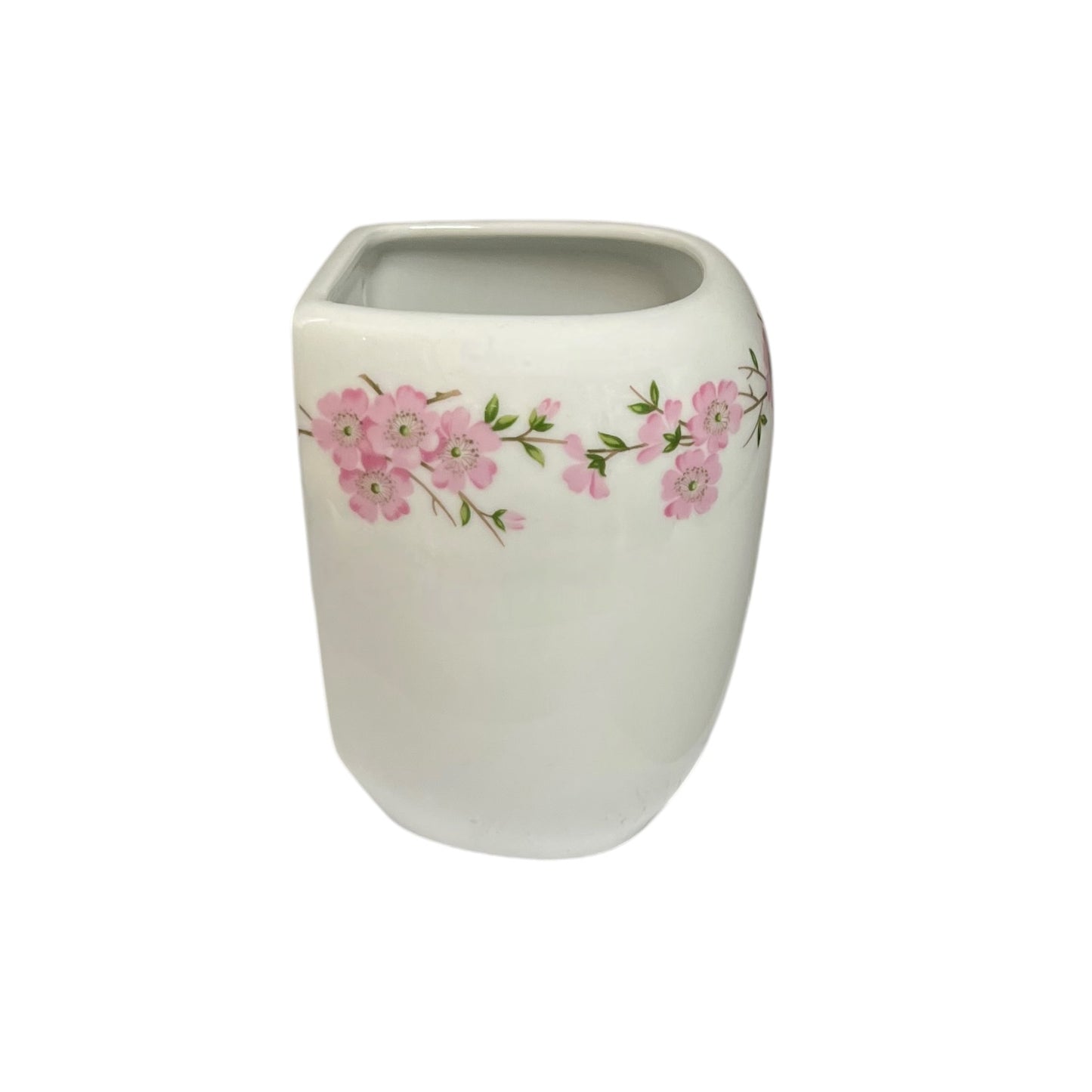 A white ceramic planter pot with a pink cherry blossom floral pattern around the middle, set against a plain white background.