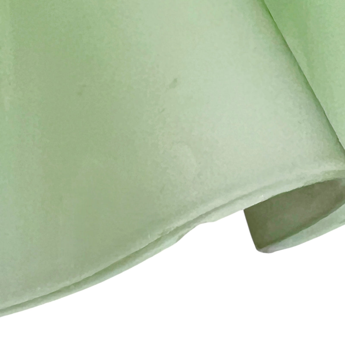 close up of a glass lampshade on a white background