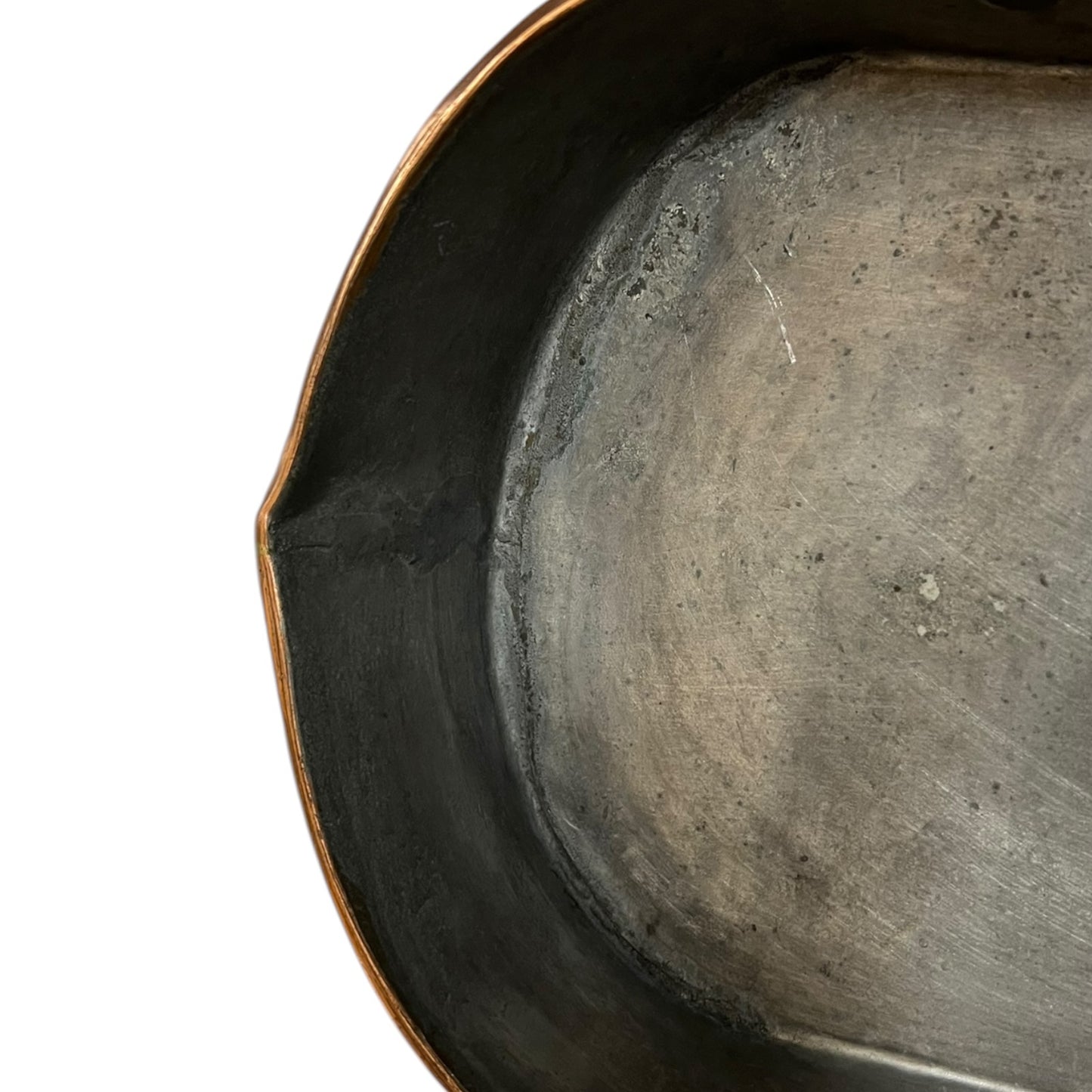 Close up of a copper roasting pan with a long handle on a white background