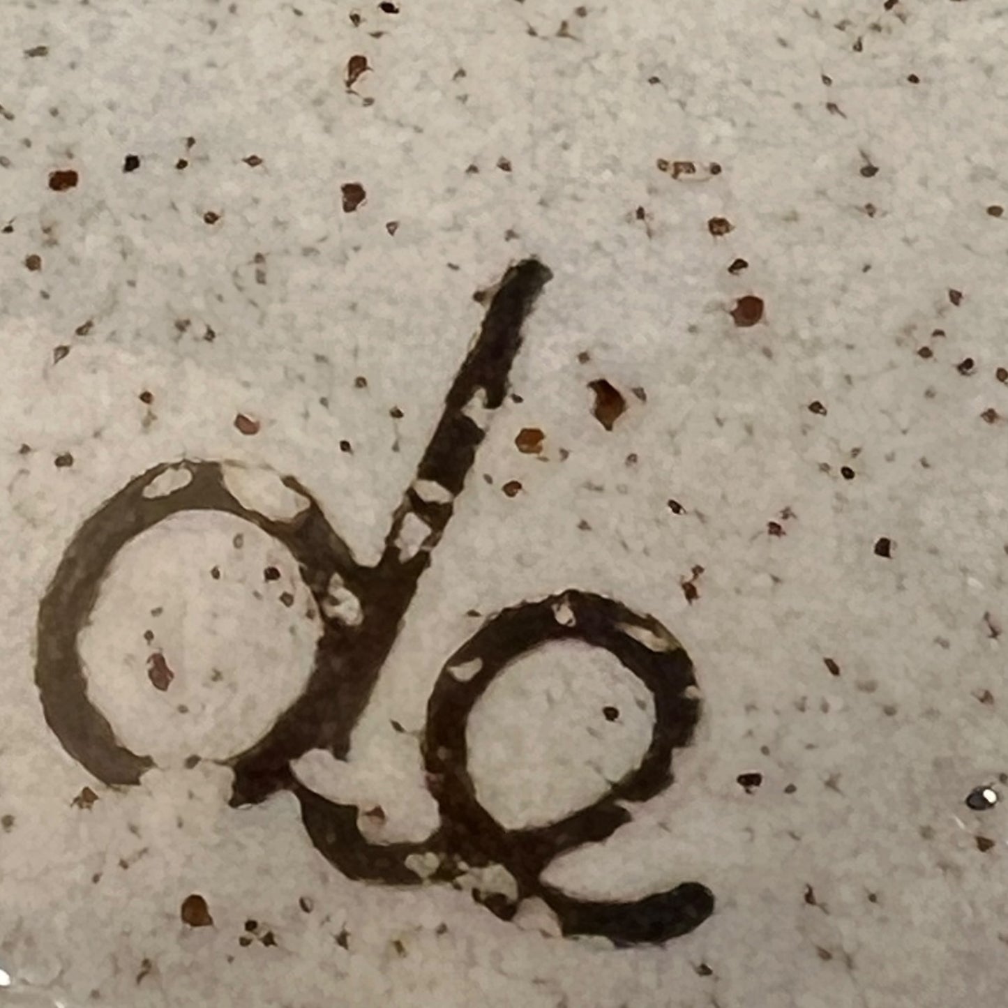 Close up of a speckled ceramic container on a white background