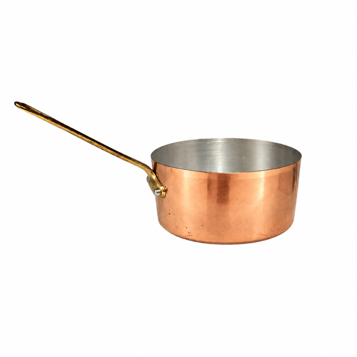 A copper saucepan with a long brass handle and a polished silver interior, shown on a plain white background.