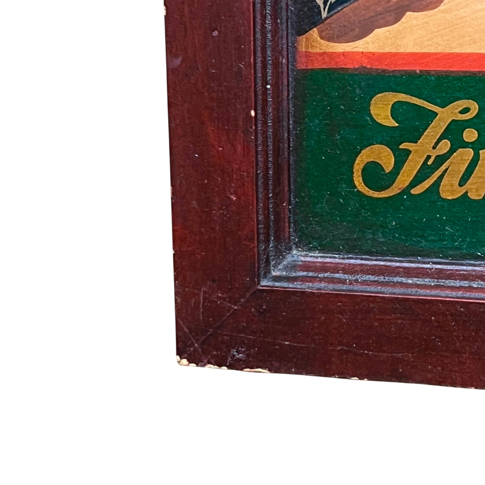 Close-up of a wooden frame with a green interior and gold lettering.