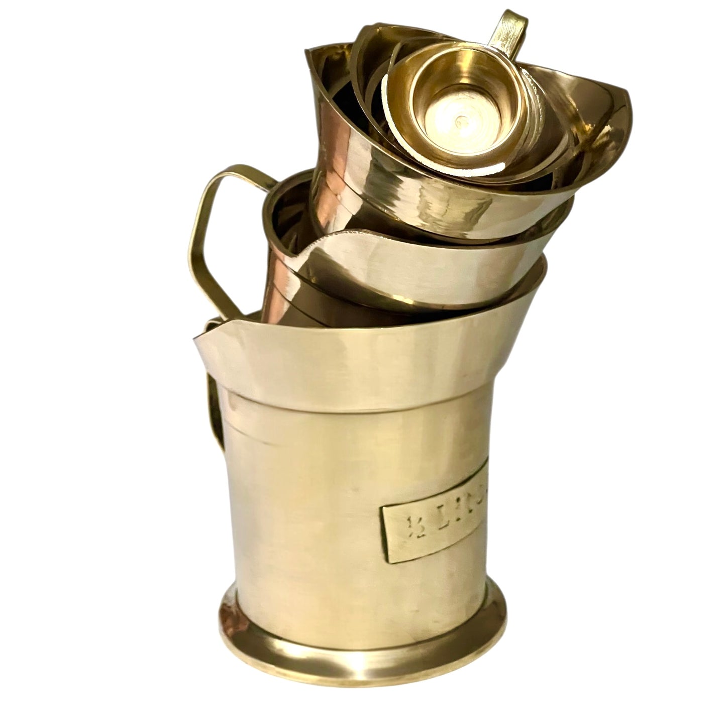 Stack of brass measuring cups on a white background