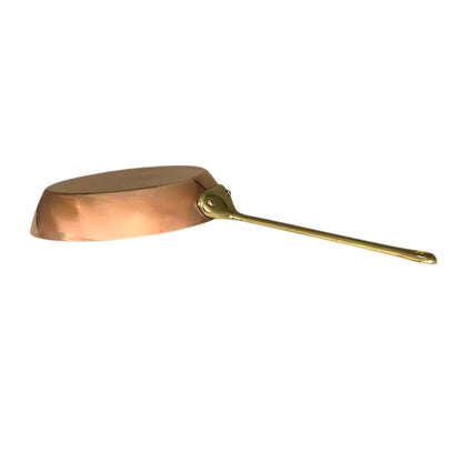 Copper frying pan with a long handle on a white background