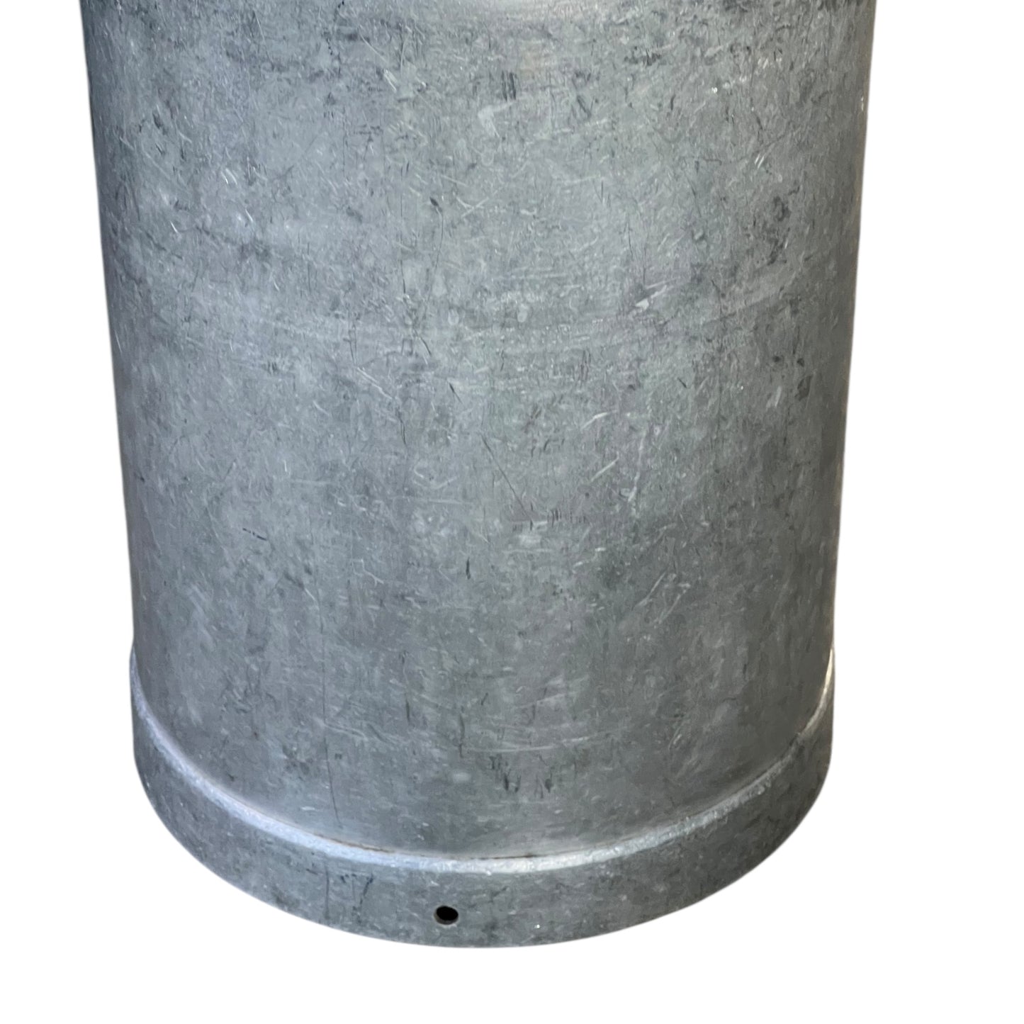 close up of metal milk churn on a white background