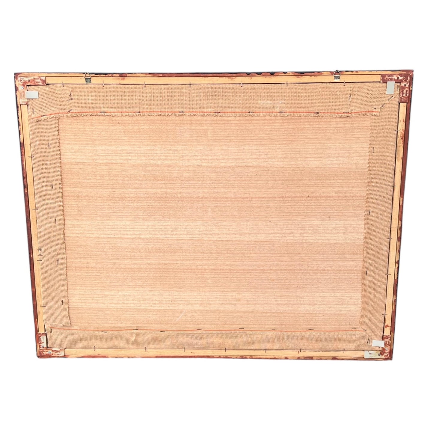 Close up of framed tapestry needlepoint with a coastal scene and wooden frame on a white background