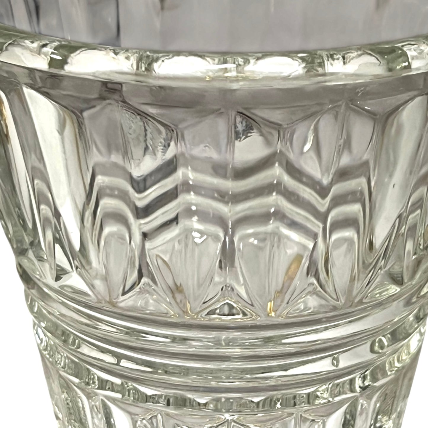 Close-up of a clear glass with diamond cut pattern