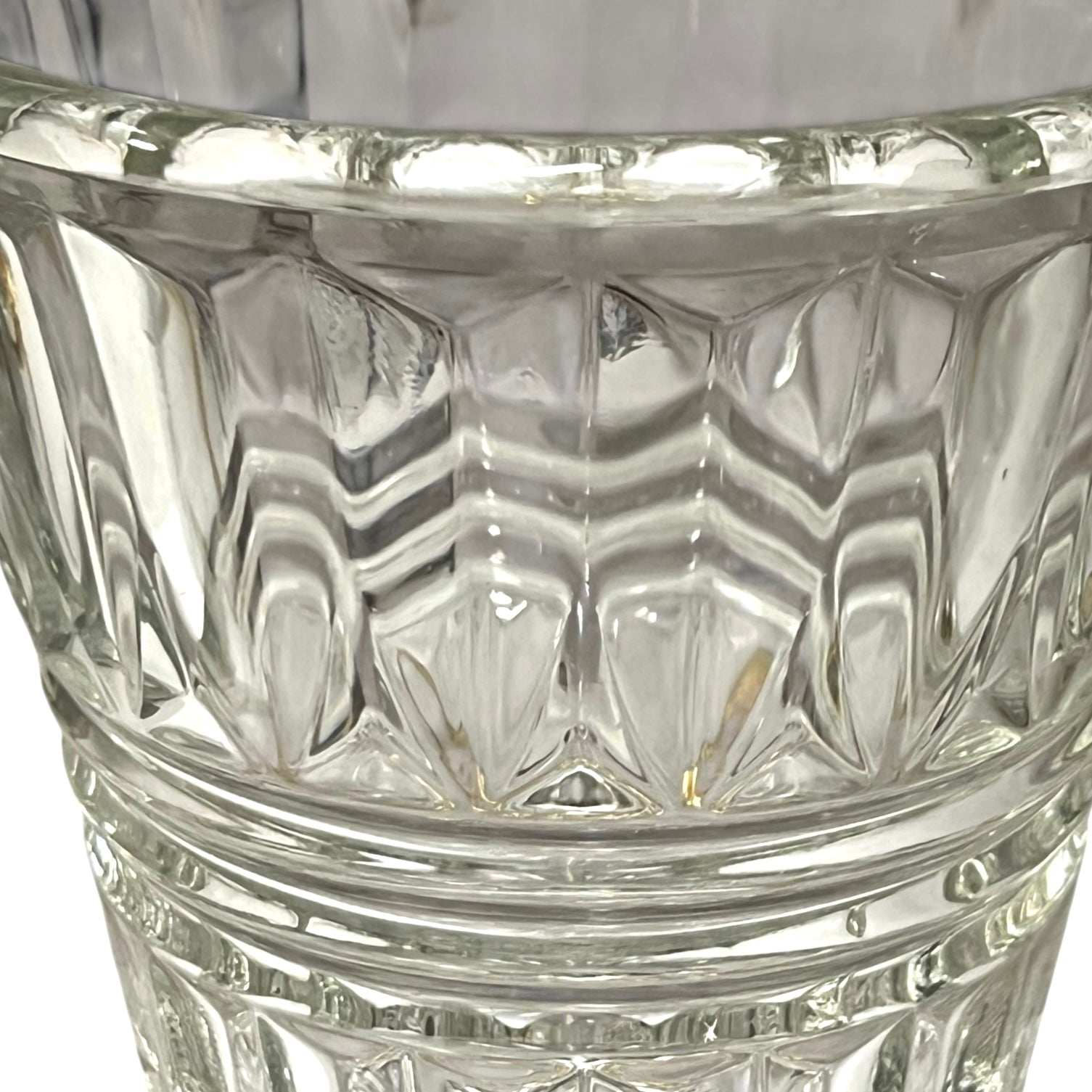 Close-up of a clear glass with diamond cut pattern