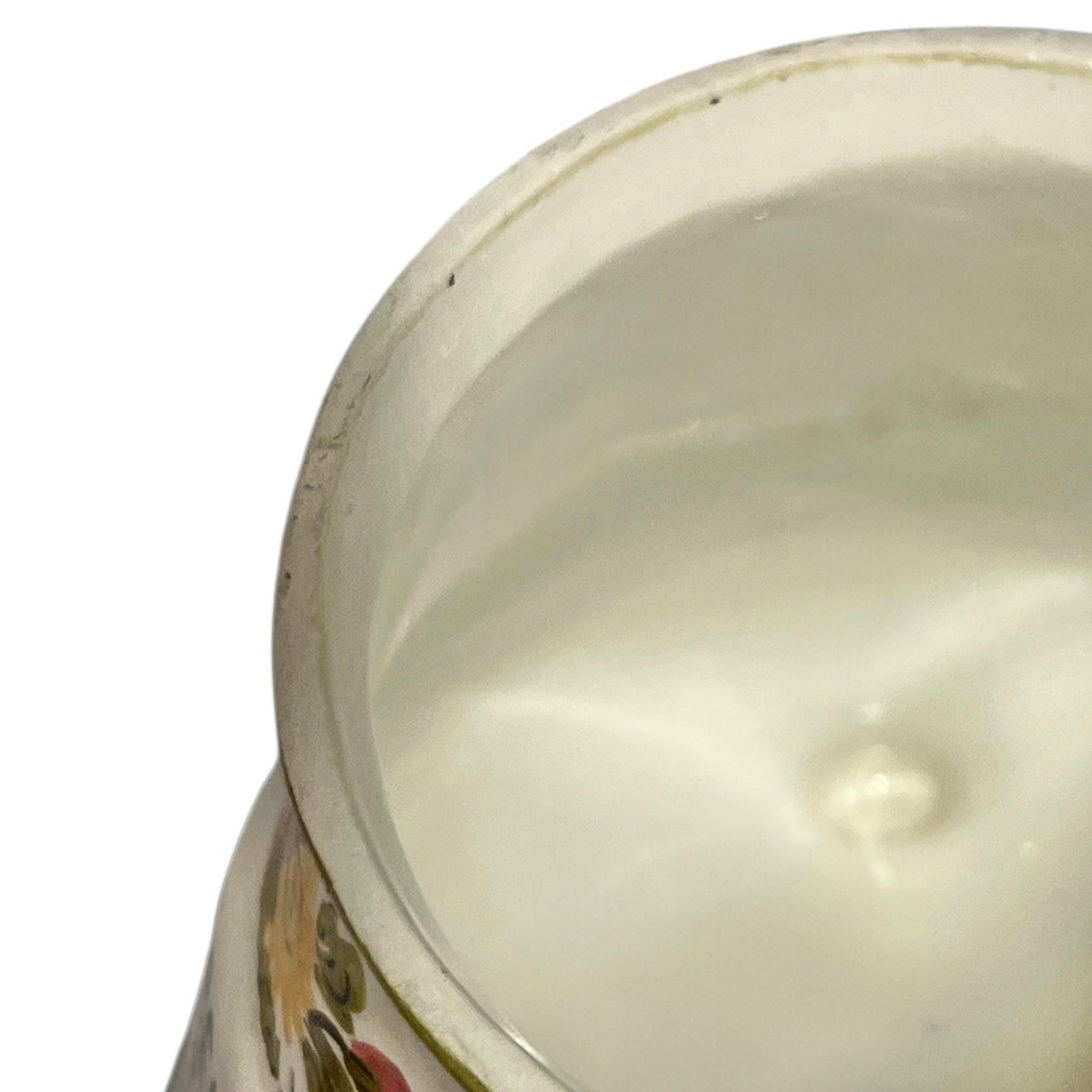 Close-up of a ceramic pot with floral patterns on a white background