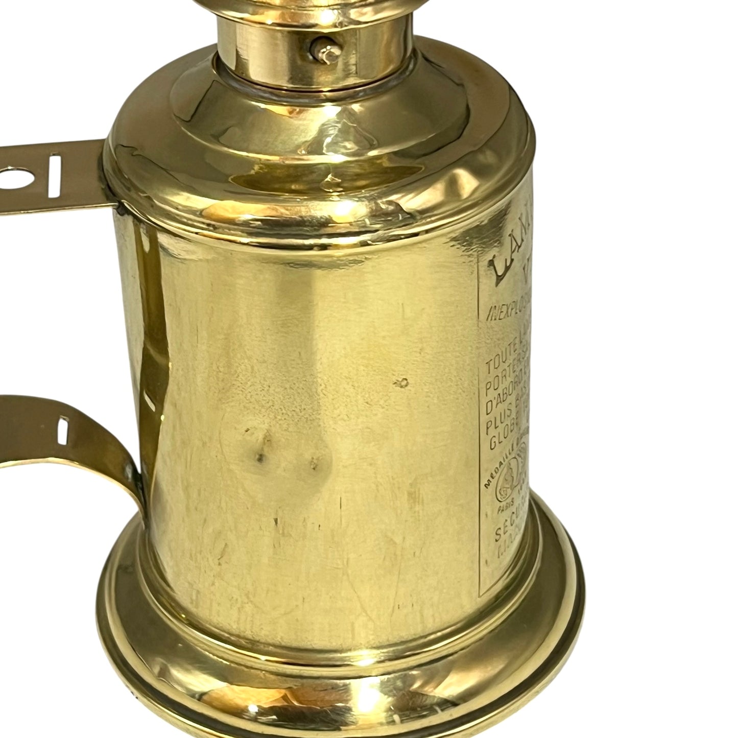 Brass lamp with visible branding on a white background