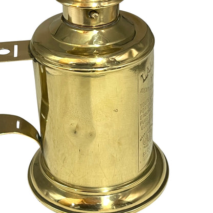 Brass lamp with visible branding on a white background