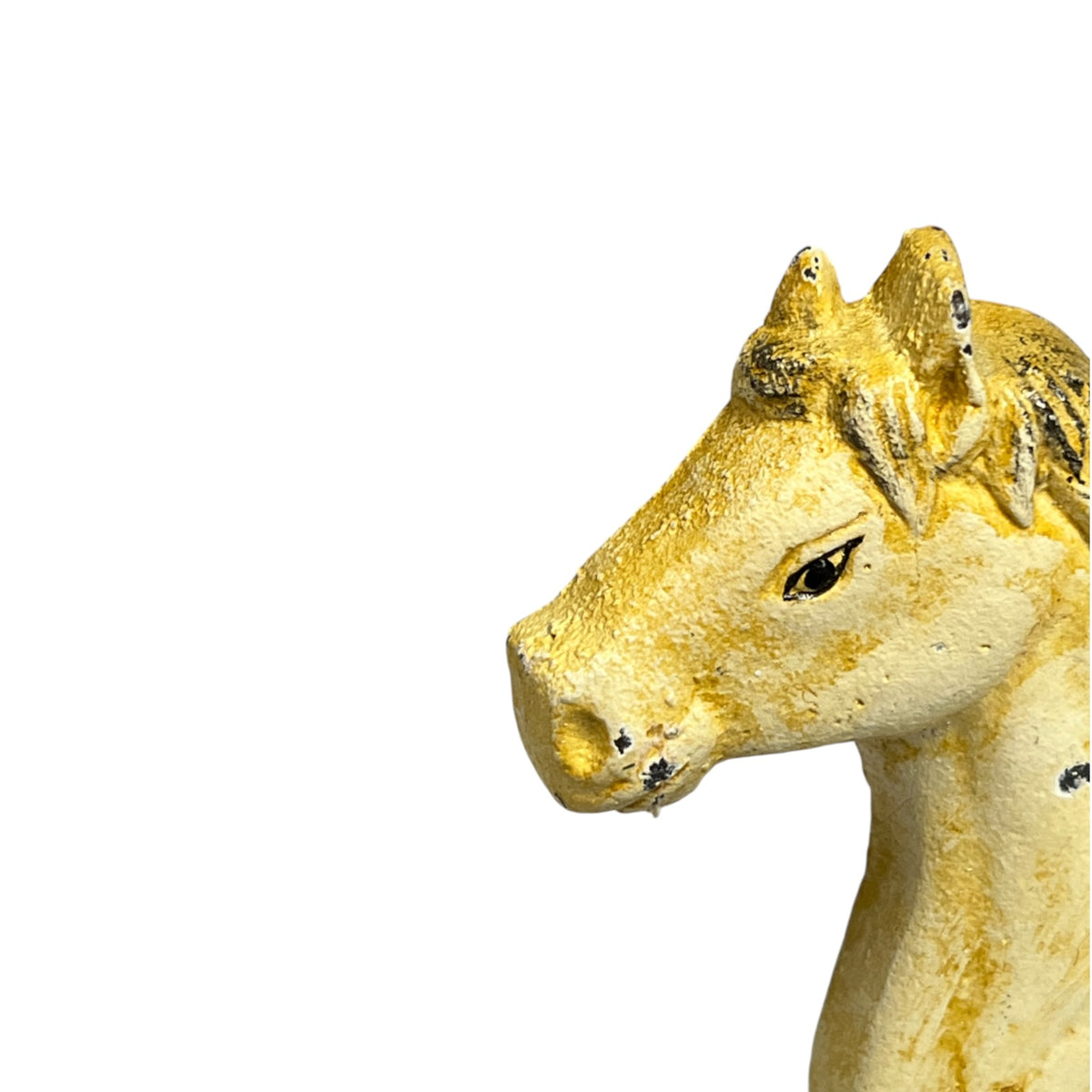A close-up side profile of a decorative horse head sculpture in a textured, rustic yellow and beige finish with dark accents, isolated on a solid white background.