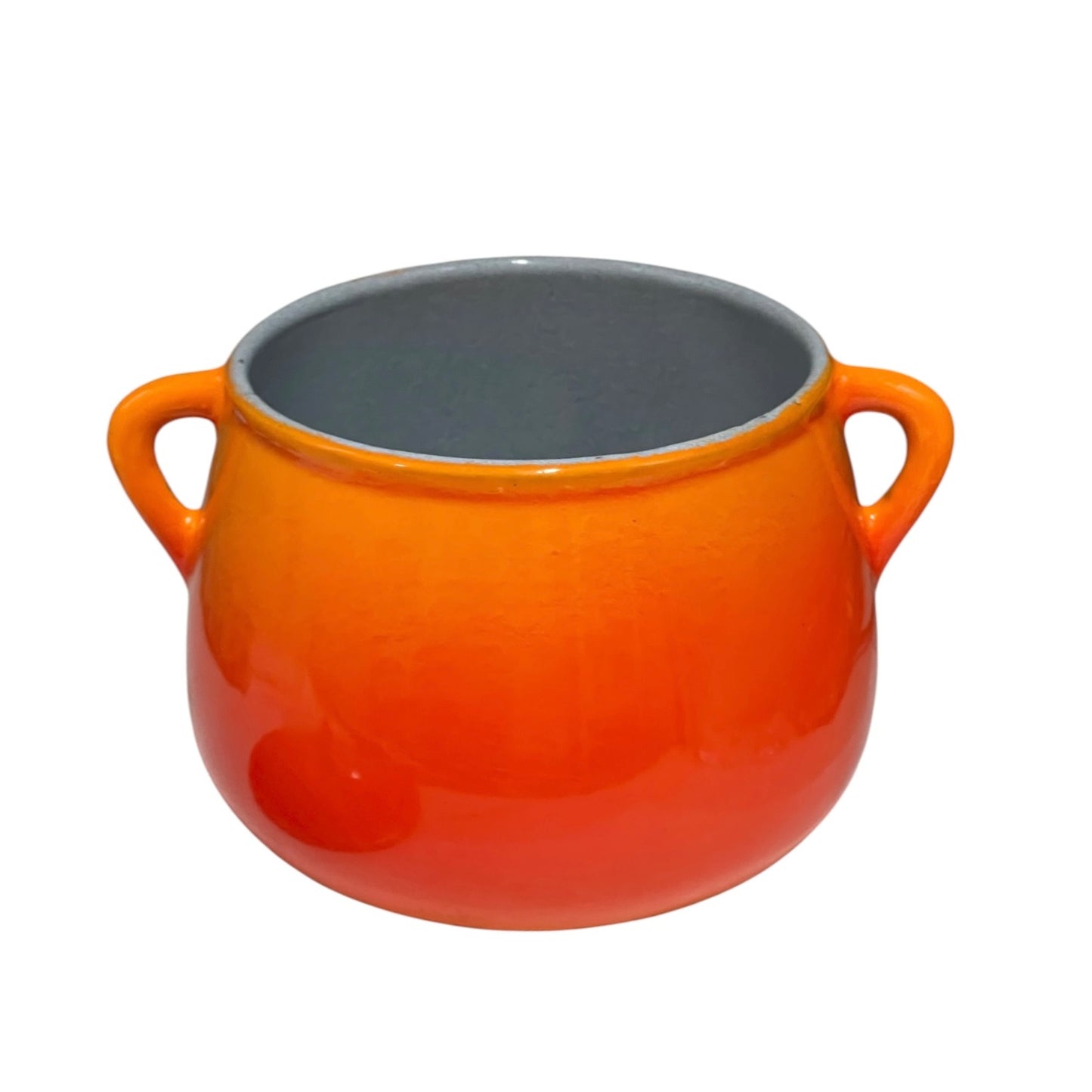 An orange ceramic pot with a smooth gradient finish, featuring two side handles and a contrasting grey glazed interior, shown against a plain white background.