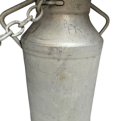Close up of a vintage metal milk churn on a white background