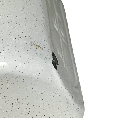 Close-up of a enamel planter with speckled pattern on a white background