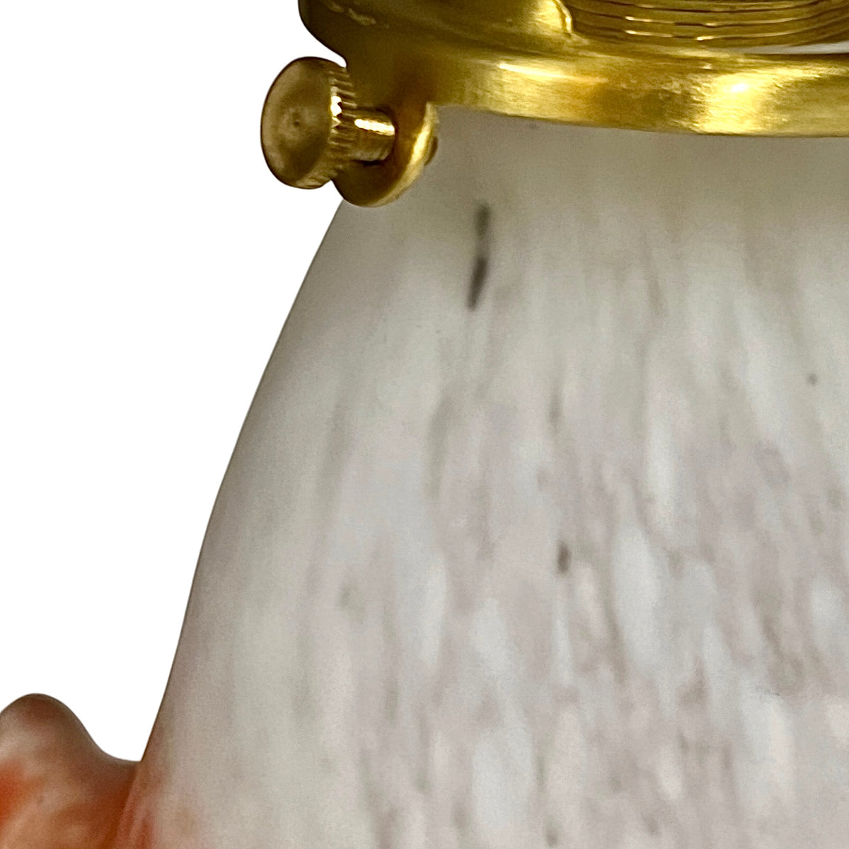 Close-up detail of a glass lampshade with subtle grey veining and a polished gold-toned metal collar and screw cap against a white background.