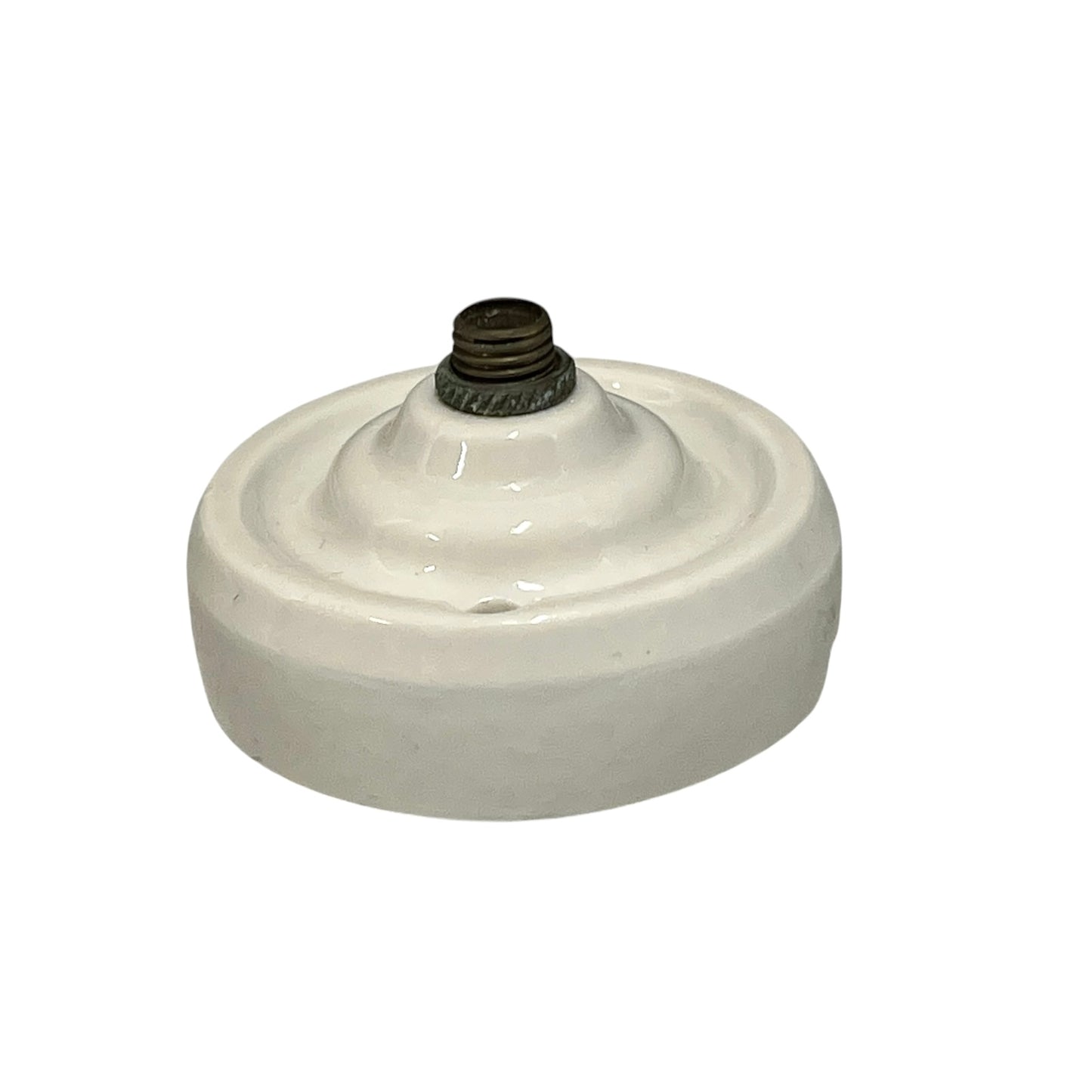 Small vintage French porcelain ceiling rose with a brass nut on a white background 