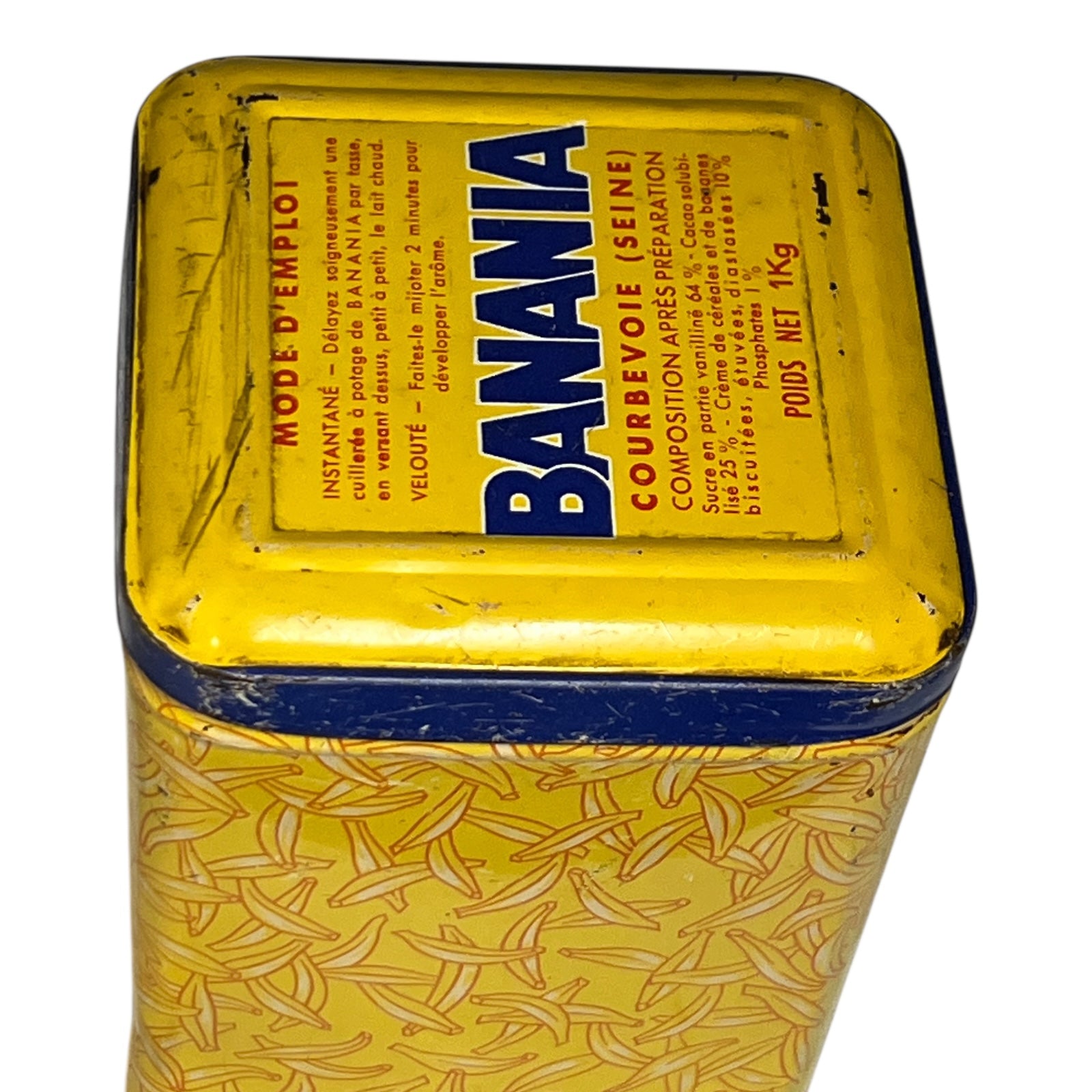 Yellow and blue tin with banana pattern and 'Banania' branding on a white background
