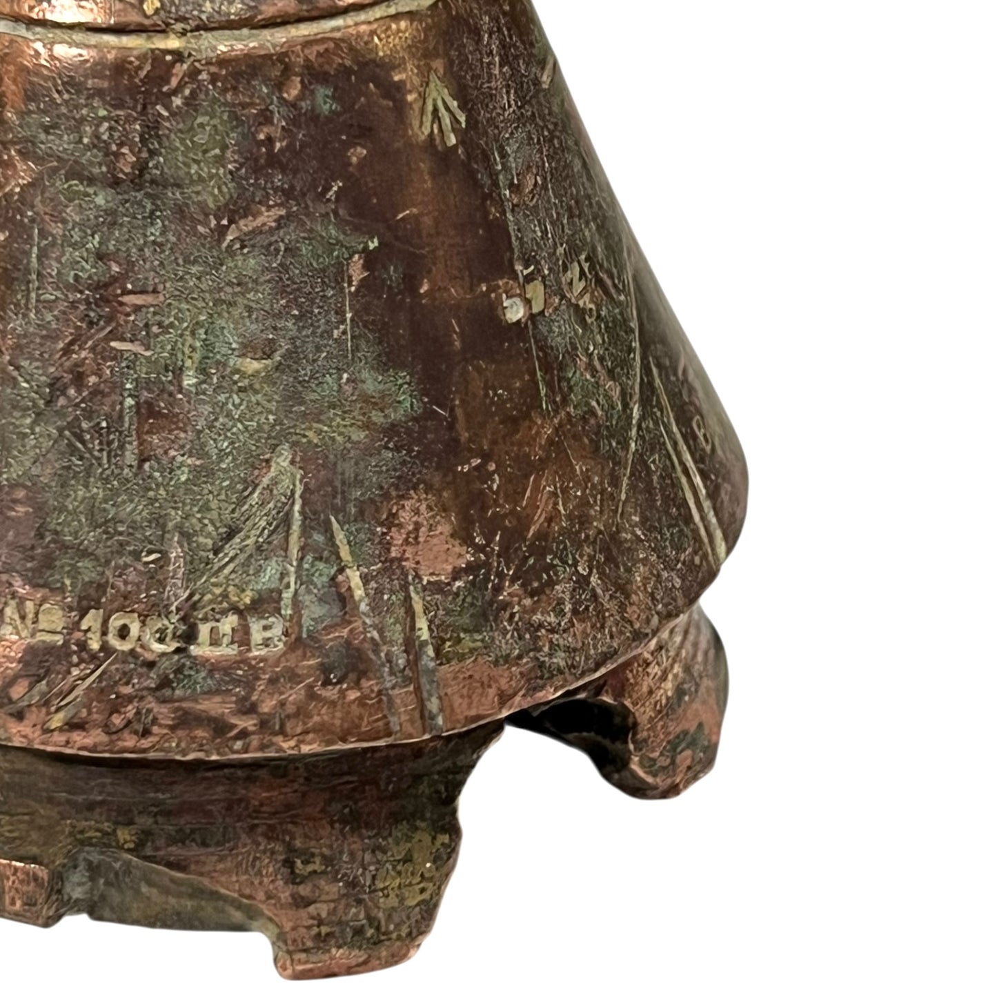 WW1 British brass fuse now repurposed as a paperweight on a white background