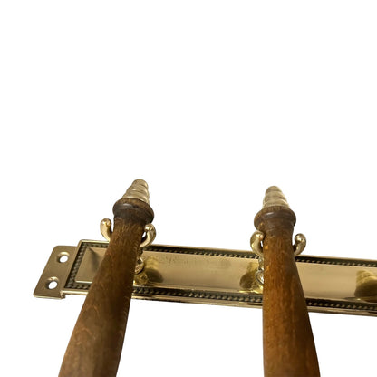 Pair of wooden handles with brass hardware on a white background