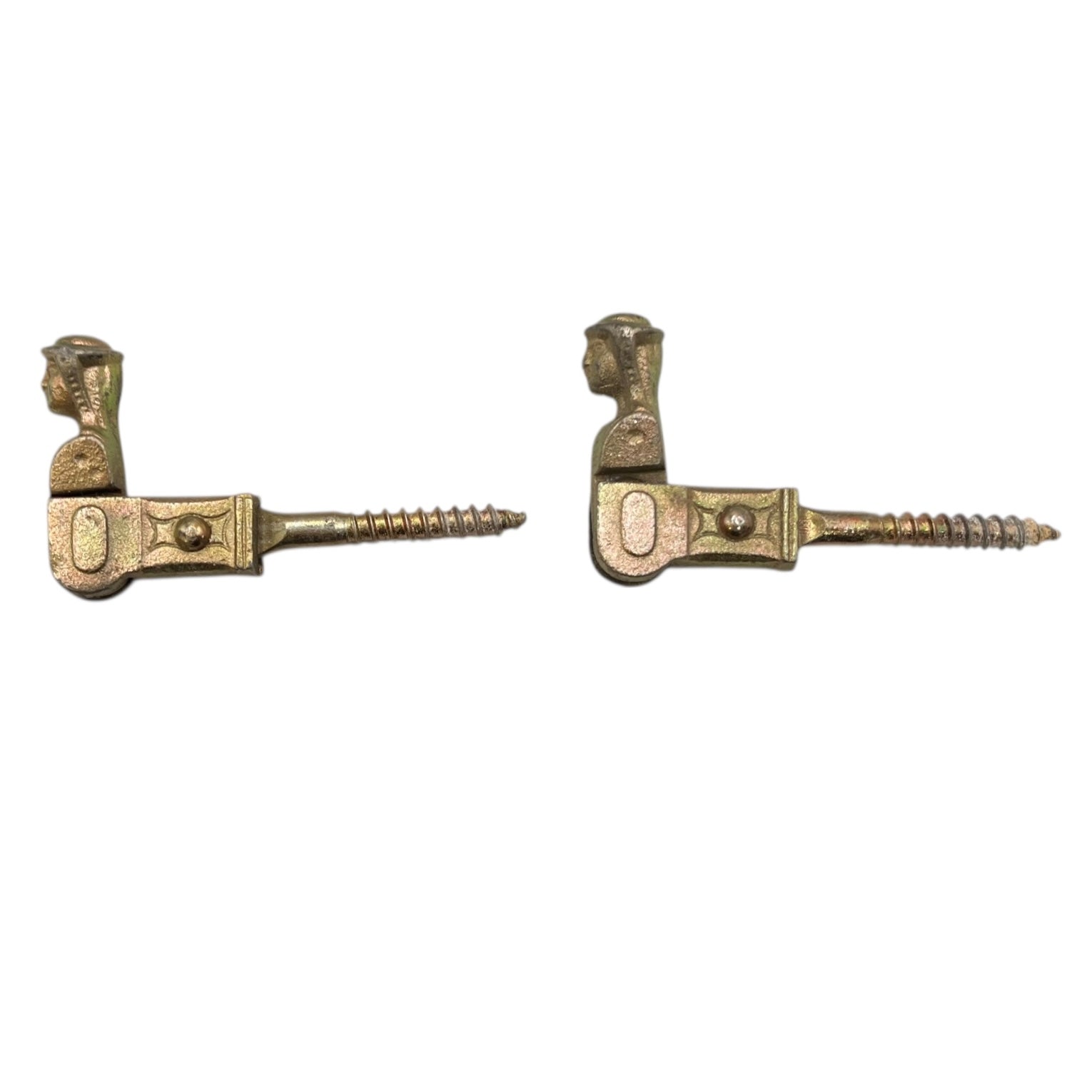 Two brass coloured French decorative shutter brackets on a white background