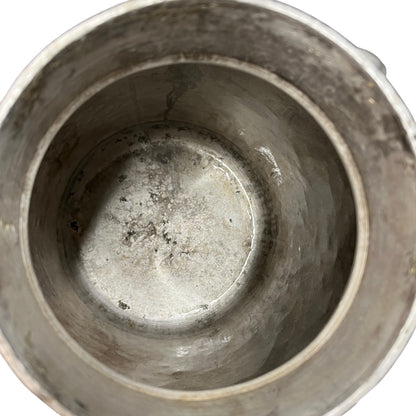 Close up of a vintage metal milk churn on a white background