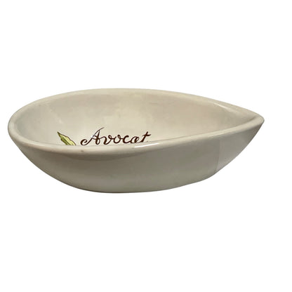 An off-white ceramic avocado-shaped bowl with the word 'Avocat' and a small green leaf printed inside, shown on a plain white background.