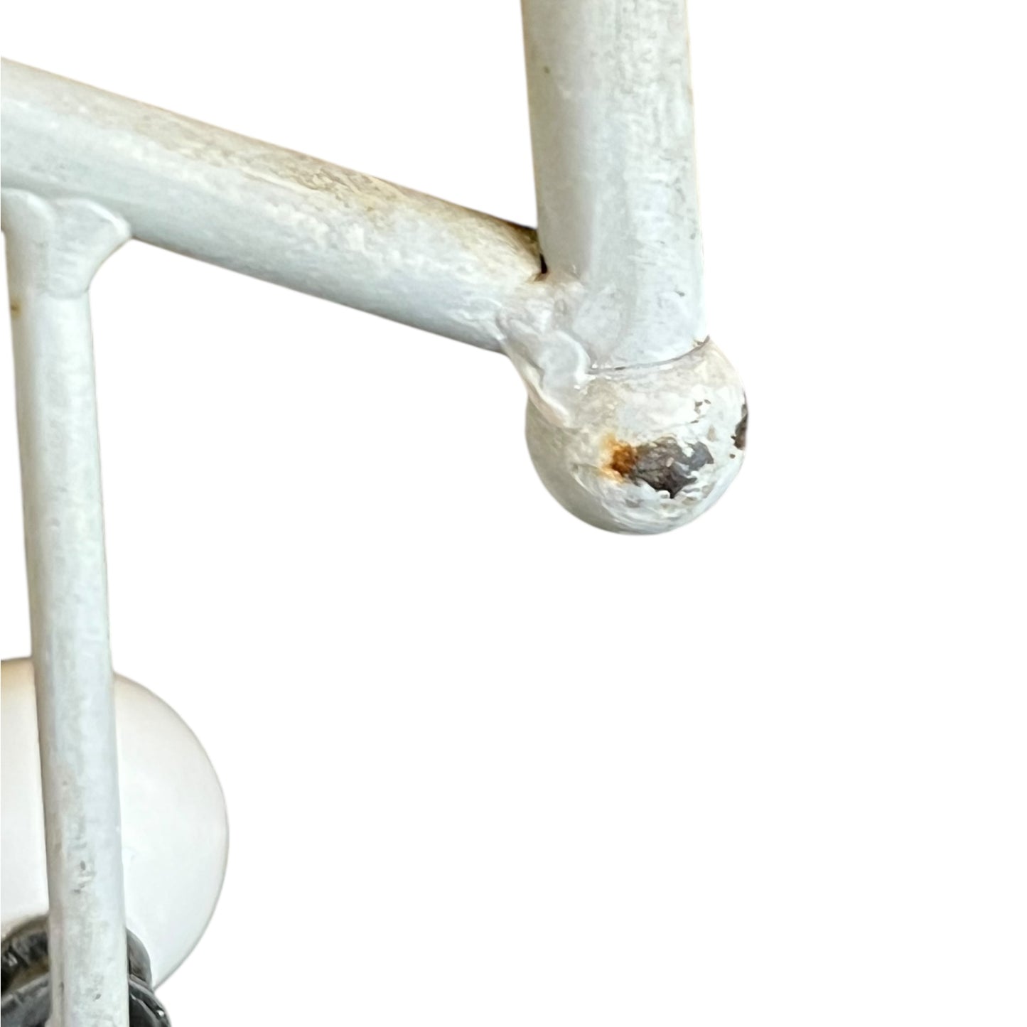 Close-up of a metal she with visible wear and tear on a white background