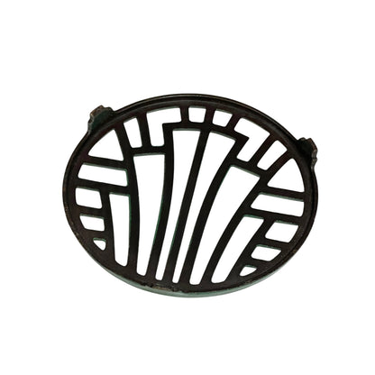 Close up of a green vintage French cast iron enamelled pan trivet on a white background