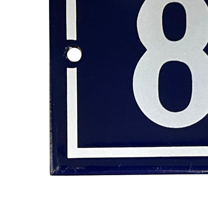 close up of a French vintage blue and white door number 88 on a white background 