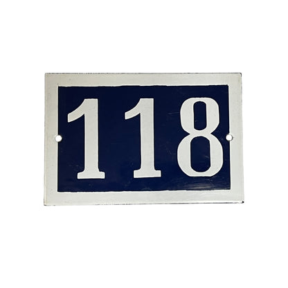 Rectangular blue sign with white numbers '118' on a white background