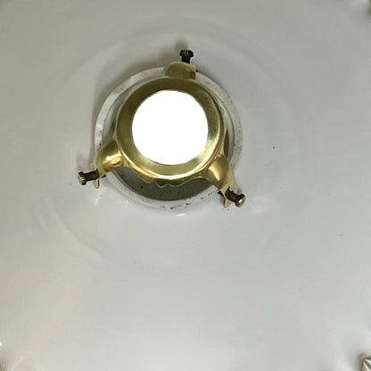 Close-up of a milk-glass frilled-edge lampshade against a white background.