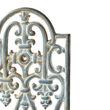close up of a metal decorative wall planter on a white background