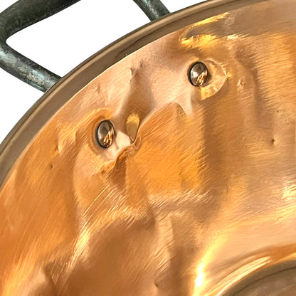 Close-up of a copper basin with a reflective finish on a white background 