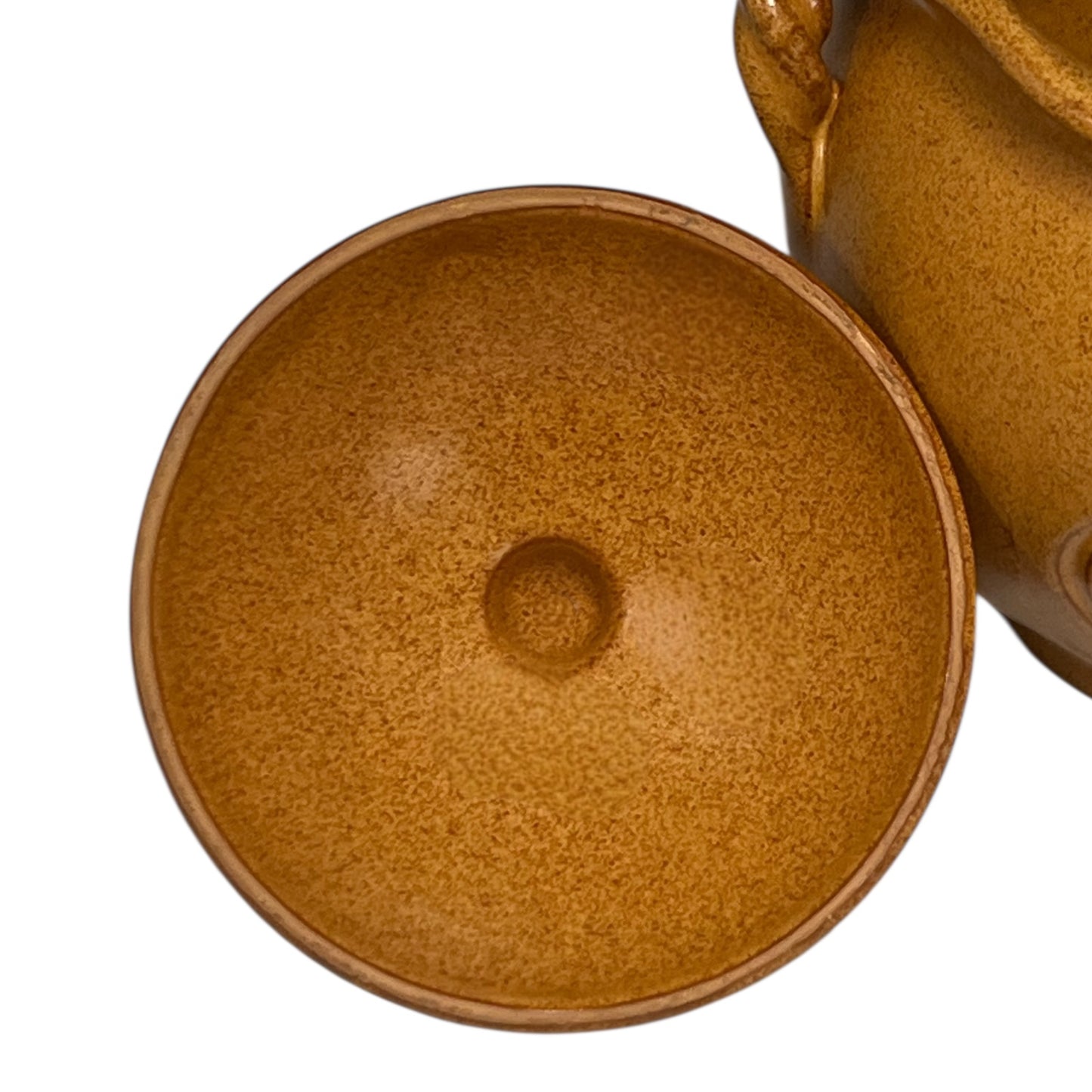 Close-up of a brown ceramic pot with lid on a white background