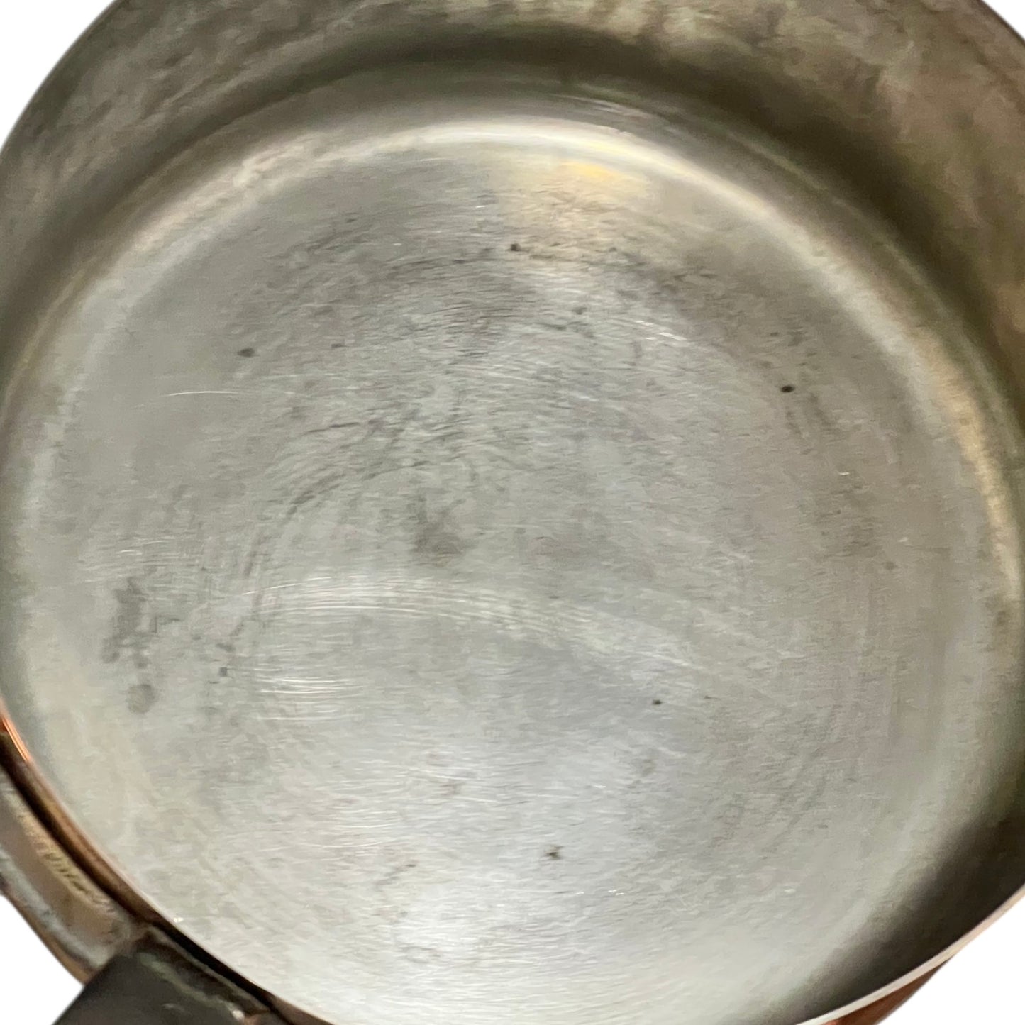 Close-up of copper cookware with iron handles on a white background