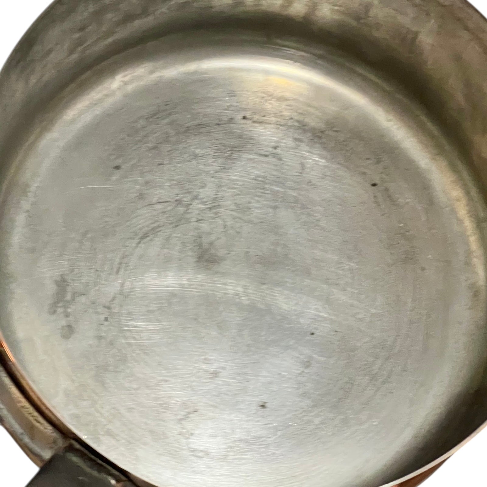 Close-up of copper cookware with iron handles on a white background