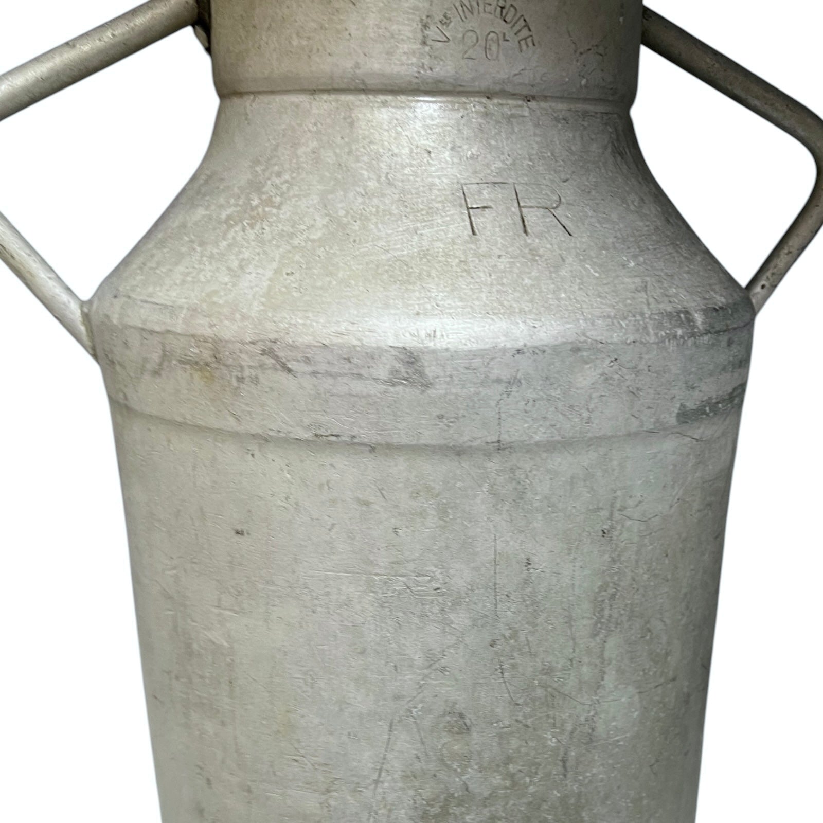 Close up of a vintage metal milk churn on a white background