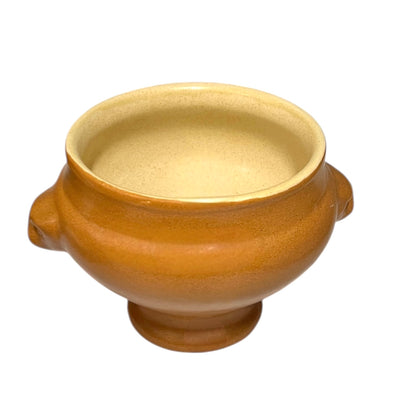 light brown ceramic French soup bowl with lions head handles on a white background 